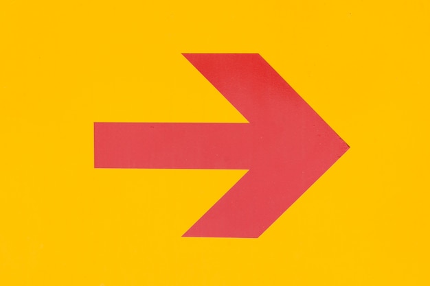 Photo red arrow on orange background