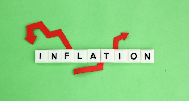 Photo red arrow and the word inflation alphabet letters the concept of inflation in business