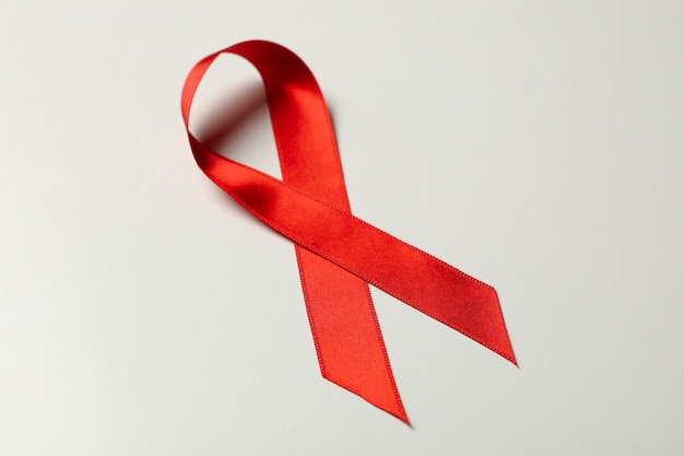 red awareness ribbon on white background