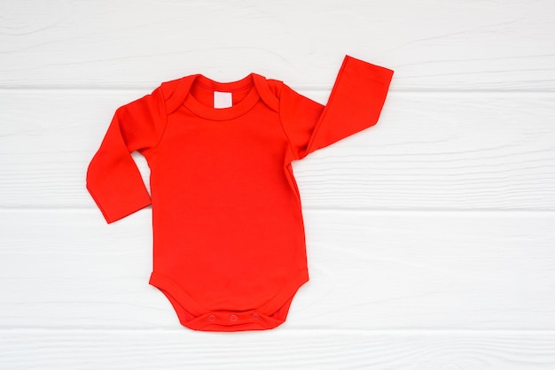 Red baby bodysuit long sleeve flatlay mockup on white wood background