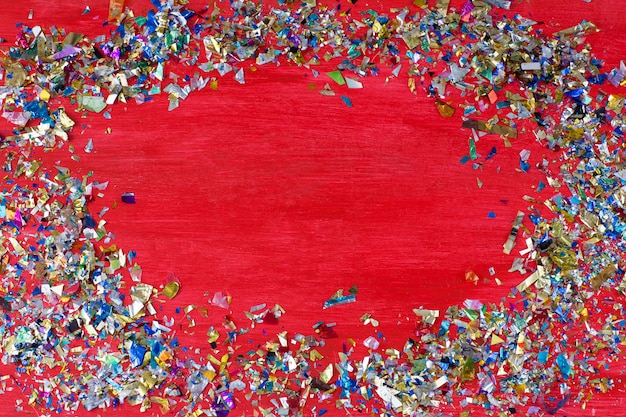 On a red background confetti scattered in a circle and in the middle 