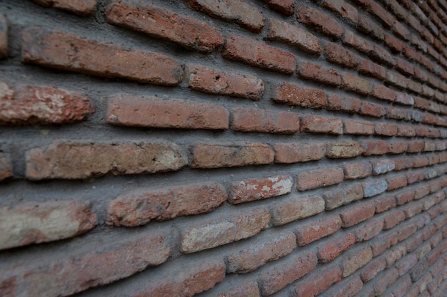 Red background of old vintage brick wall texture. Close up view of old stone brick wall with medieval masonry, perspective photography High quality photo