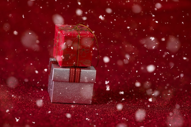 Red background with gift box and snow