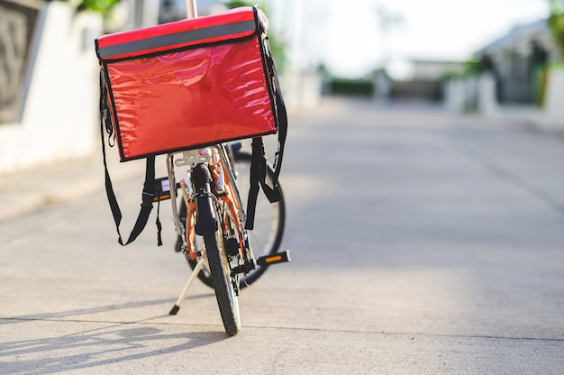 Red bag placed on a bicycle prepared to deliver parcels to customers