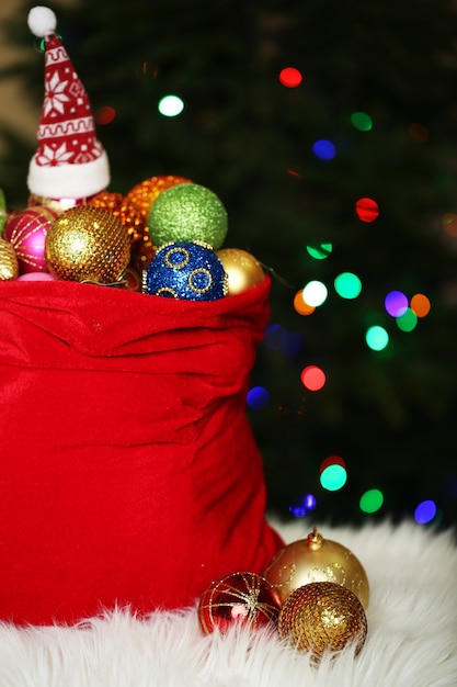 Red bag with Christmas toys on Christmas tree background