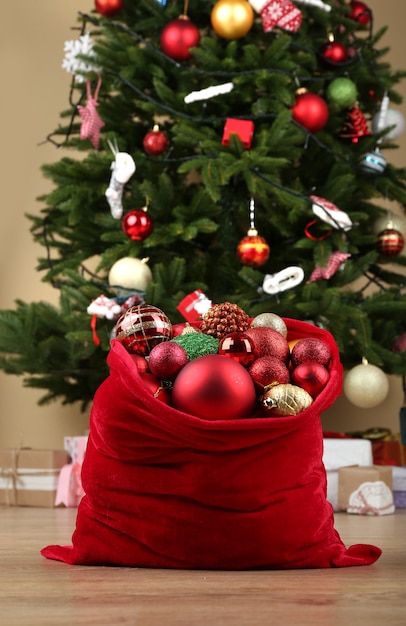 Red bag with Christmas toys and gifts in room