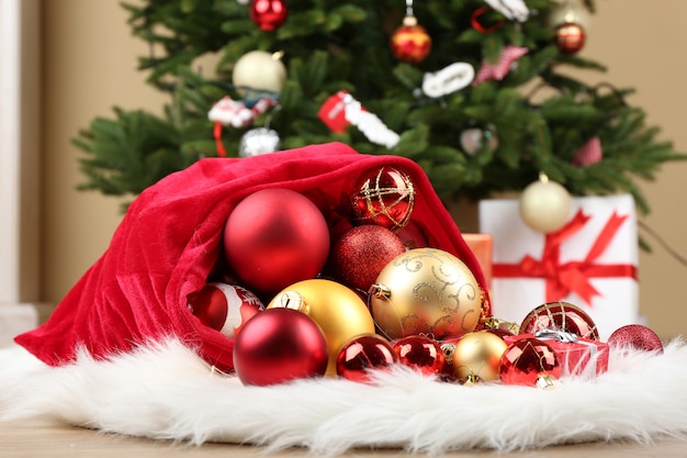 Red bag with Christmas toys and gifts in room