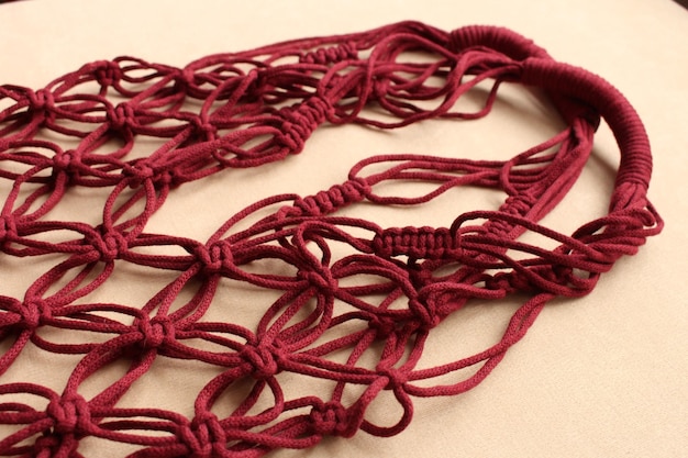 A red bag with many knots