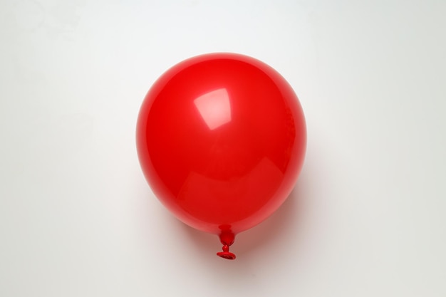 Red balloon on white background top view