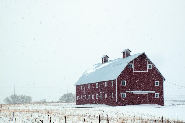 Red barn in snow storm in Colorado.