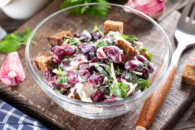 Red bean salad with croutons on the plate. Healthy food, diet