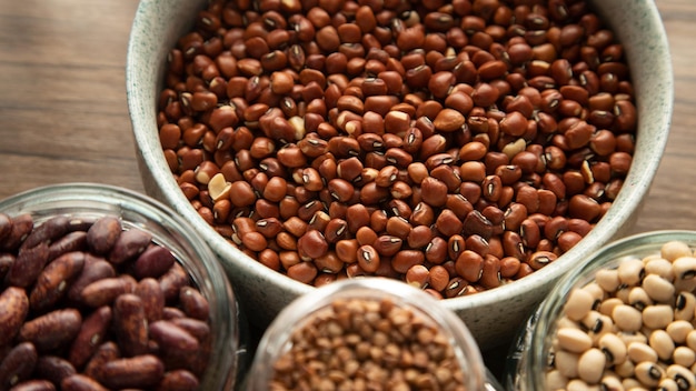 Red beans in bowls on wooden table