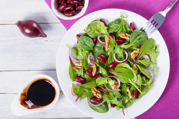 Red beans salad with mix of lettuce leaves and walnuts