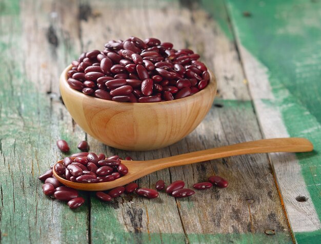 Red beans in the wooden bowl on old wooden