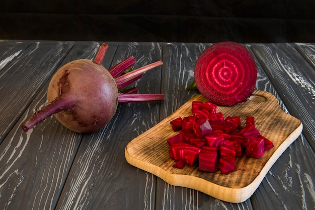 Red beets on a cutting board with a knife