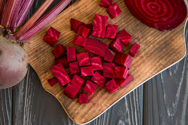 Red beets on a cutting board with a knife