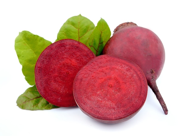 Red beets with swiss chard leafs on white background