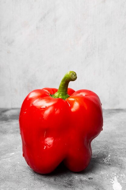 Red bell pepper on grey space