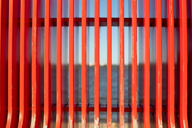 Red bench in detail texture of vertical lines park furniture