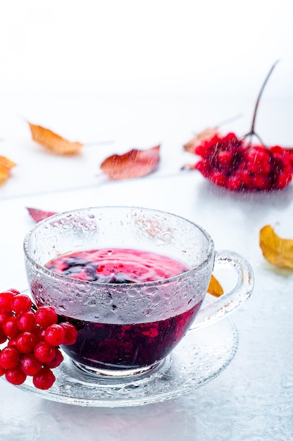 Red berries  viburnum and cup of tea  