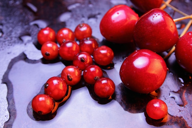 黒い背景に水の滴と赤い果実健康食品のコンセプト上からの眺め甘い果実のクローズ アップ