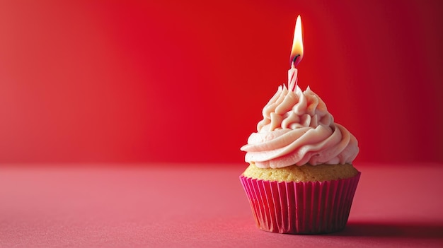 Red Birthday Cupcake with Pink Frosting and Lit Candle