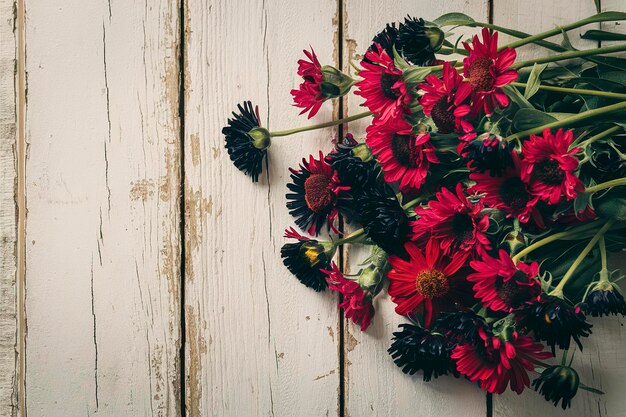 Photo red and black cornflowers on a old white wooden background