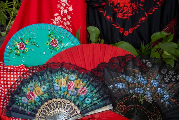 A red and black fan with a floral design on it