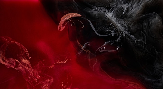 Red black pigment swirling ink abstract background, liquid smoke paint underwater