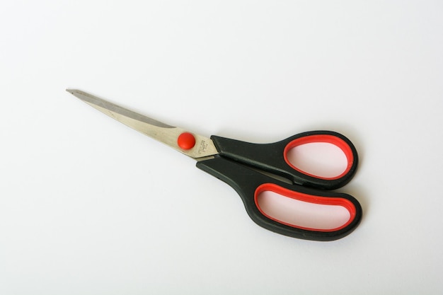 red and black scissors isolated on white