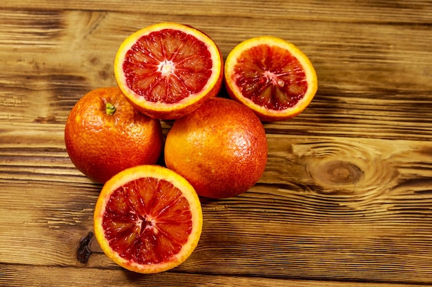 Red blood oranges on wooden table