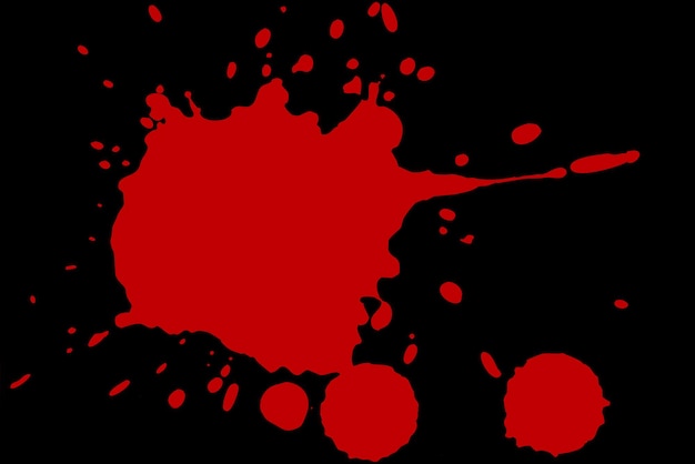 Red blot on a black background Spots of paint on a piece of paper
