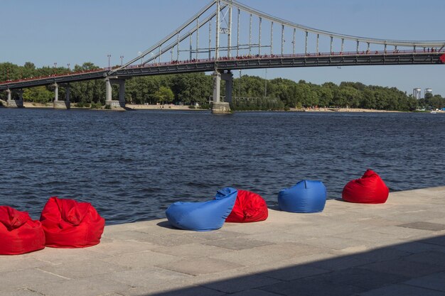 Red and blue beach bean bags on the river bank