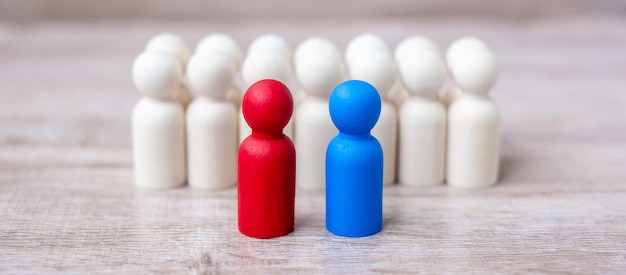 Red and blue businessmen with crowd of wooden men. Candidate, leadership, business, team, teamwork and Human resource management concept