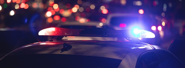 Red and blue light flasher Police car at night time in the city