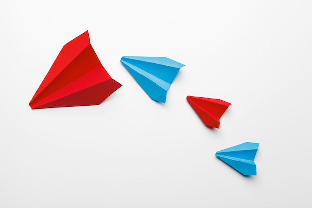 Red and blue paper planes on white background