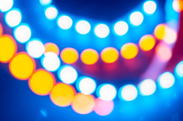 Red blue yellow neon garlands of bokeh lights. Festive background of retro colors.