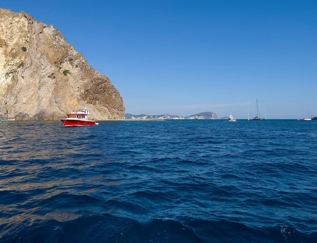 The red boat on the turquoise Mediterranean Sea