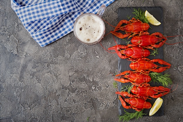 Red boiled craw fishes on table in rustic style
