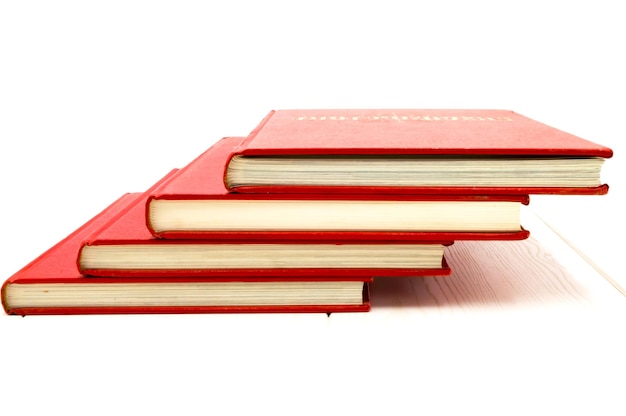 Photo red books flip over on a floor with white background