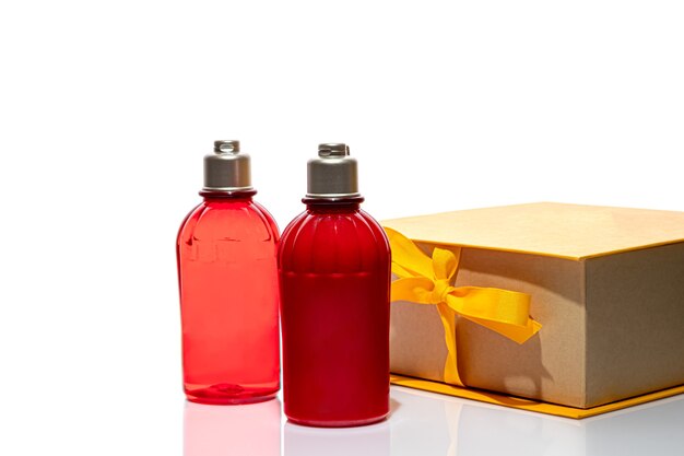 Red bottles for shower gel and cream on white