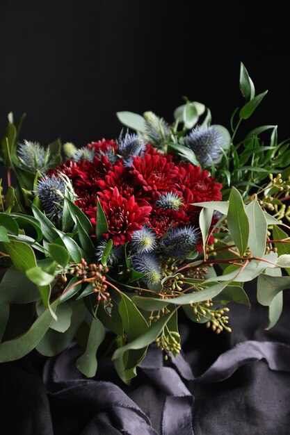 Red bouquet of the bride on a dark background, Selective focus