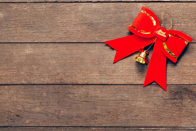 Red bow christmas on wood background with copyspace.