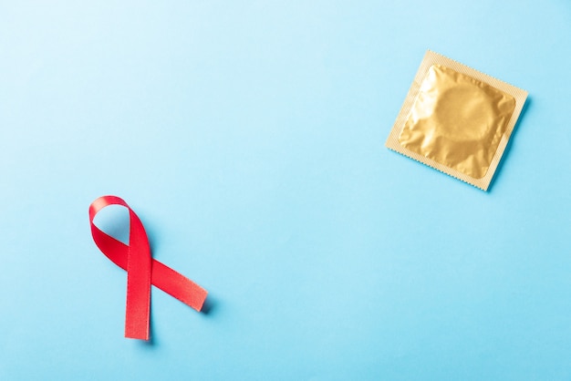 Red bow ribbon symbol HIV AIDS cancer awareness and condom