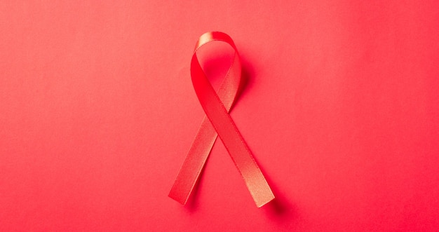 Red bow ribbon symbol HIV AIDS cancer awareness