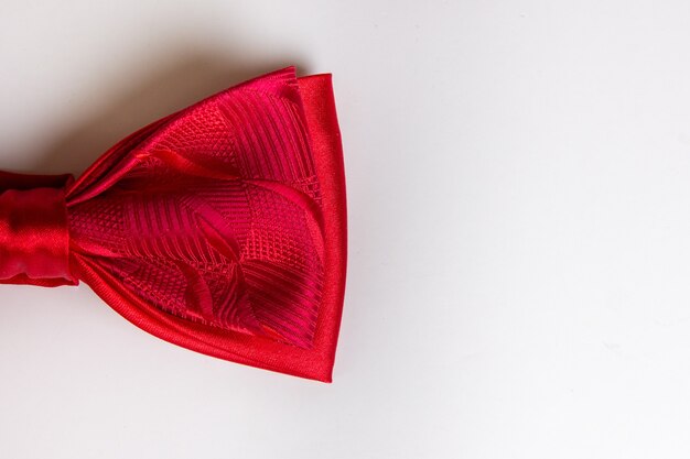 Red bow tie close-up. white background. free space for the
inscription. a men's accessory.