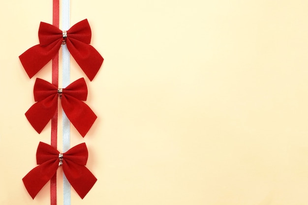 Red bows on a ribbon top view.