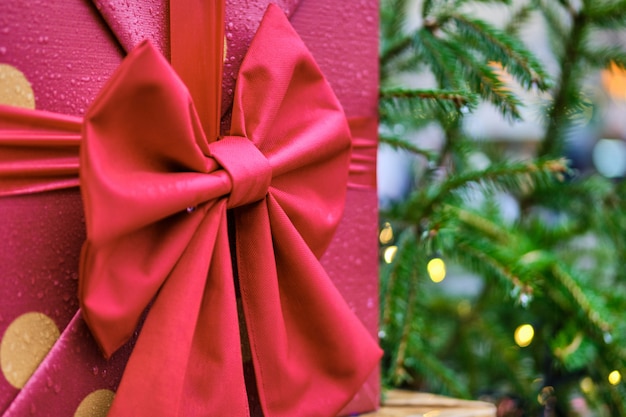 Red box of gifts with a bow of the christmas tree.