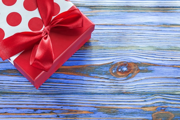 Red boxed present on vintage wooden board