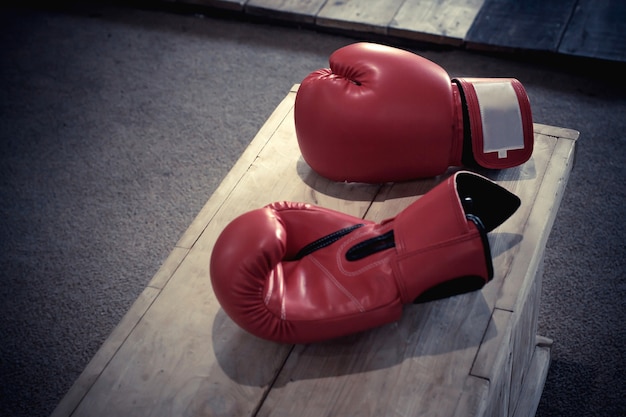 Red boxing gloves on wood table